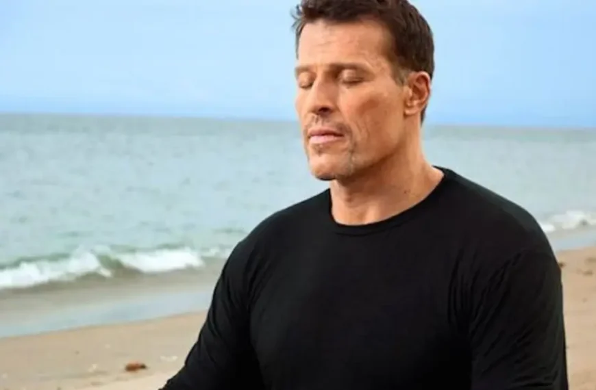 tony robbins priming morning routine + Tony Robbins is sitting on the beach, with his eyes closed, meditating