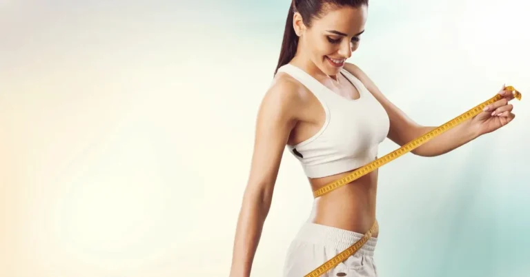 weight loss morning drink + A woman is measuring her waist with a tape measure