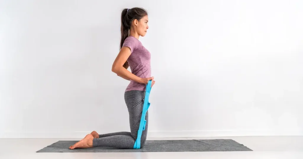 pilates workout full body + A woman is exercising with a resistance band on a workout mat