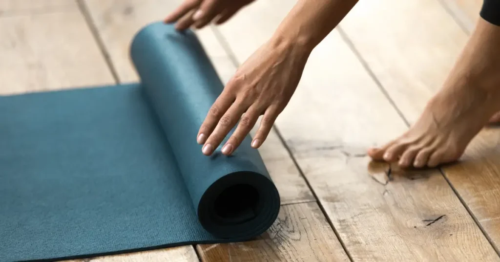 pilates workout full body + A woman is unrolling her Pilates mat