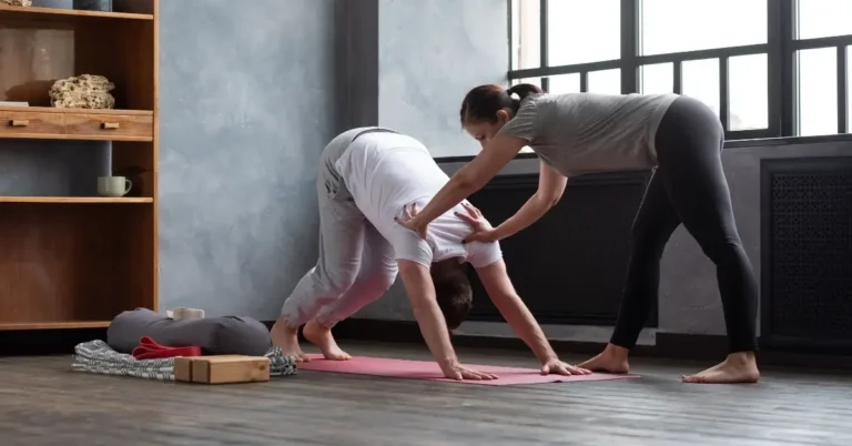 beginner pilates workout + A man is doing Pilates, and a woman is supporting him