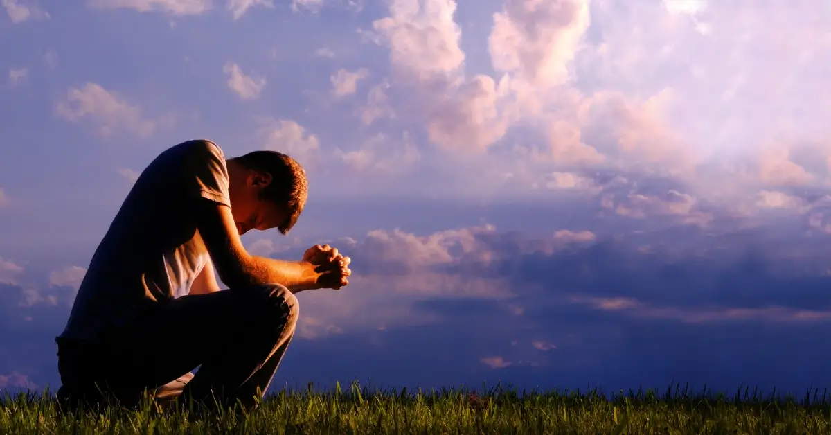 good morning prayer for him + A man is sitting on the grass, praying