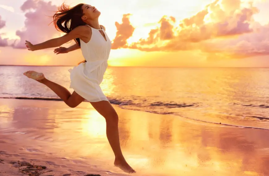 Affirmations For Happiness: a woman walk on a beach and is happy